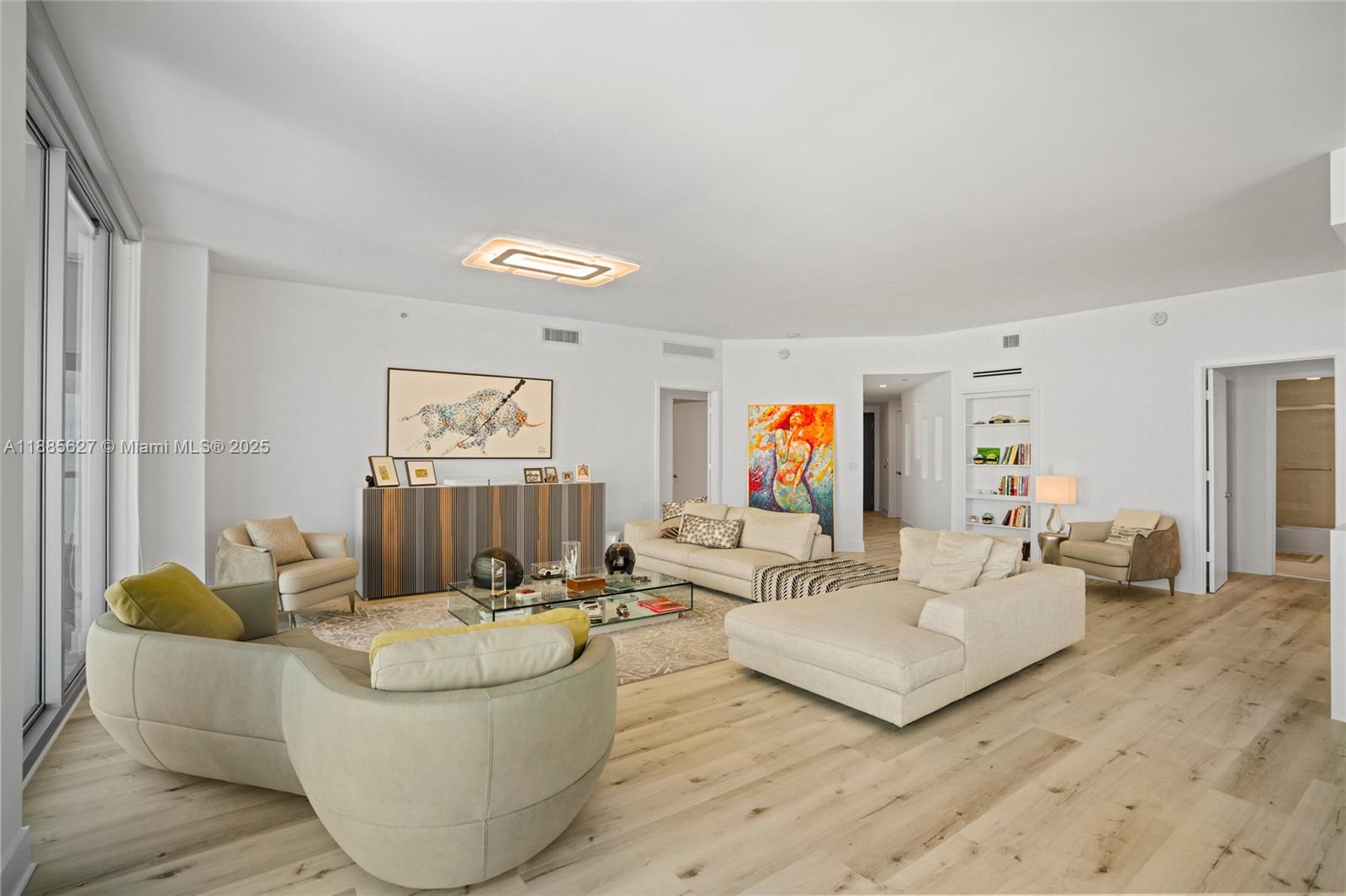 17111 Biscayne Boulevard, Unit 401 North Miami Beach, FL 33160 - Photo 5 of 66 a living room with furniture and wall paintings