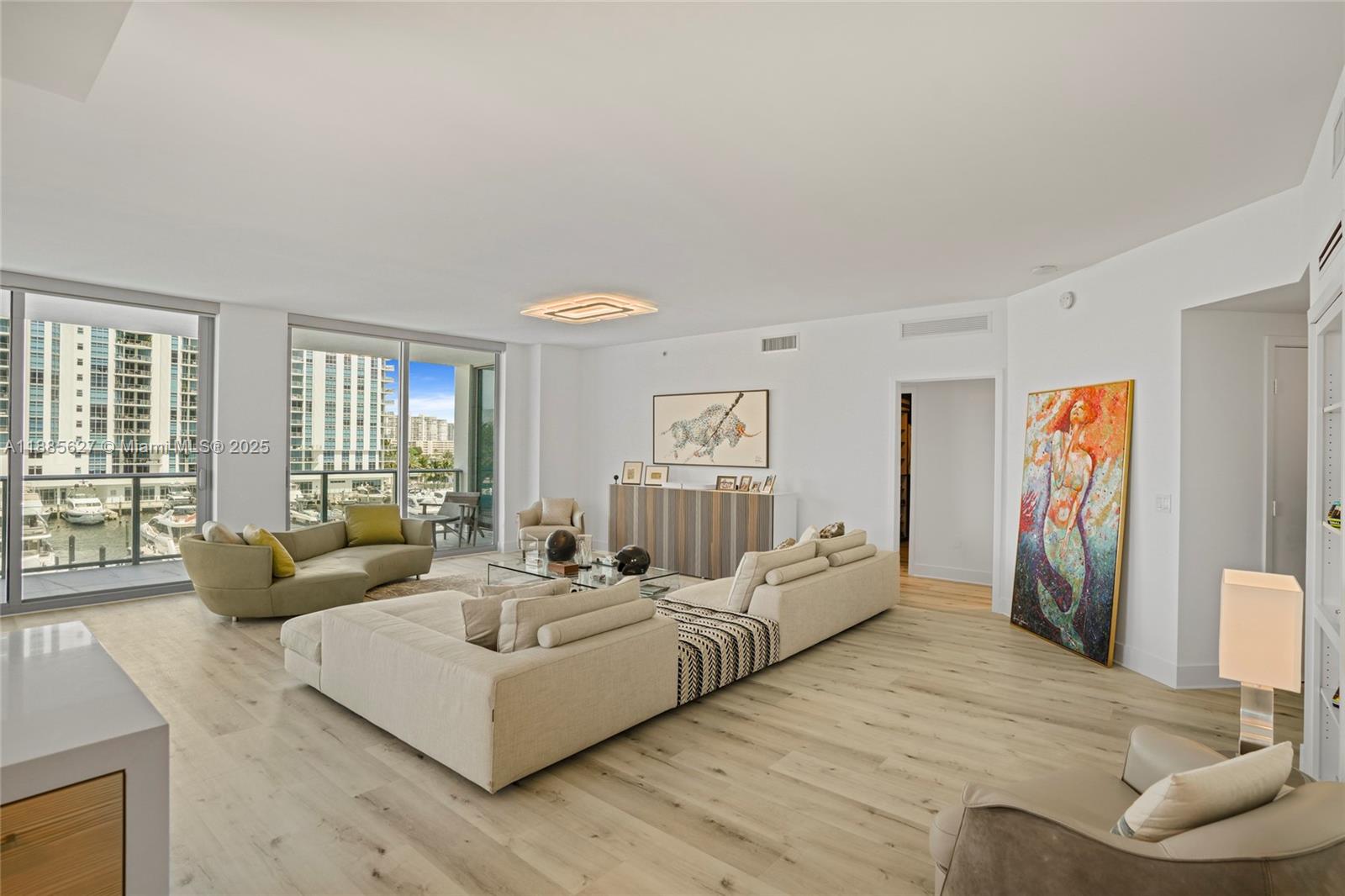 17111 Biscayne Boulevard, Unit 401 North Miami Beach, FL 33160 - Photo 6 of 66 a living room with furniture and a large window