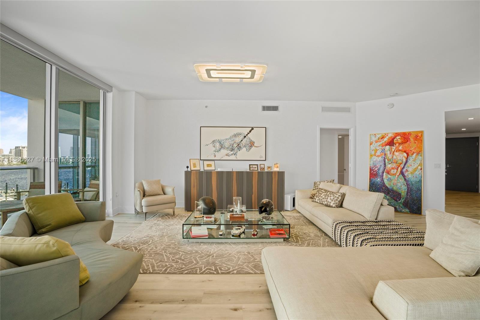 17111 Biscayne Boulevard, Unit 401 North Miami Beach, FL 33160 - Photo 9 of 66 a living room with furniture and a large window