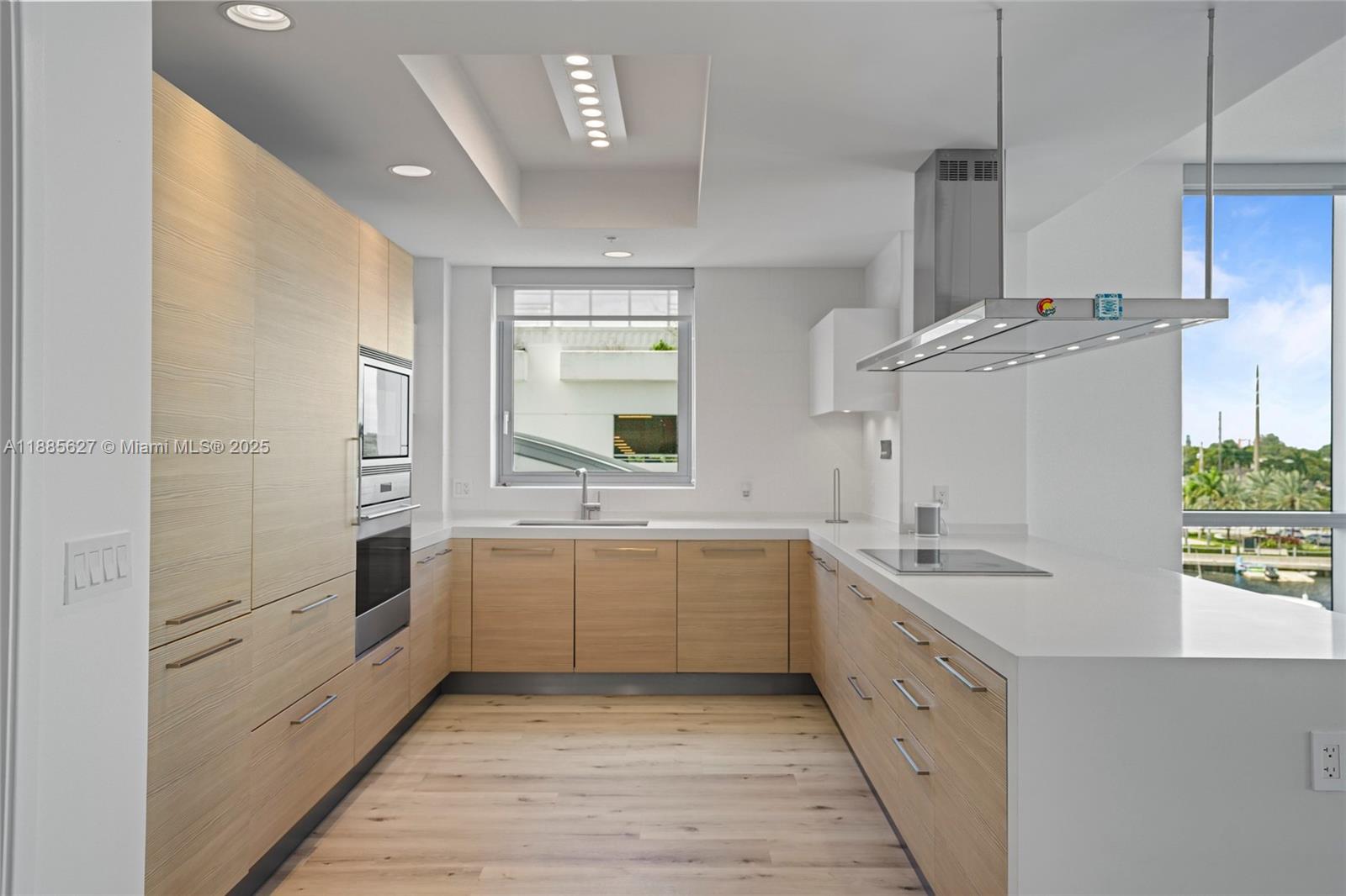 17111 Biscayne Boulevard, Unit 401 North Miami Beach, FL 33160 - Photo 10 of 66 a large white kitchen with a stove a sink dishwasher and a refrigerator
