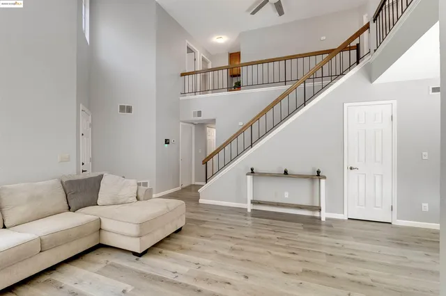 a living room with furniture and stairs