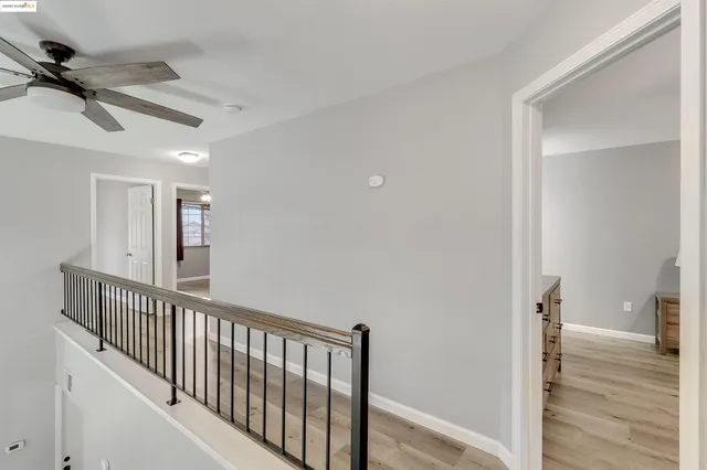 a view of a hallway with wooden floor and entryway