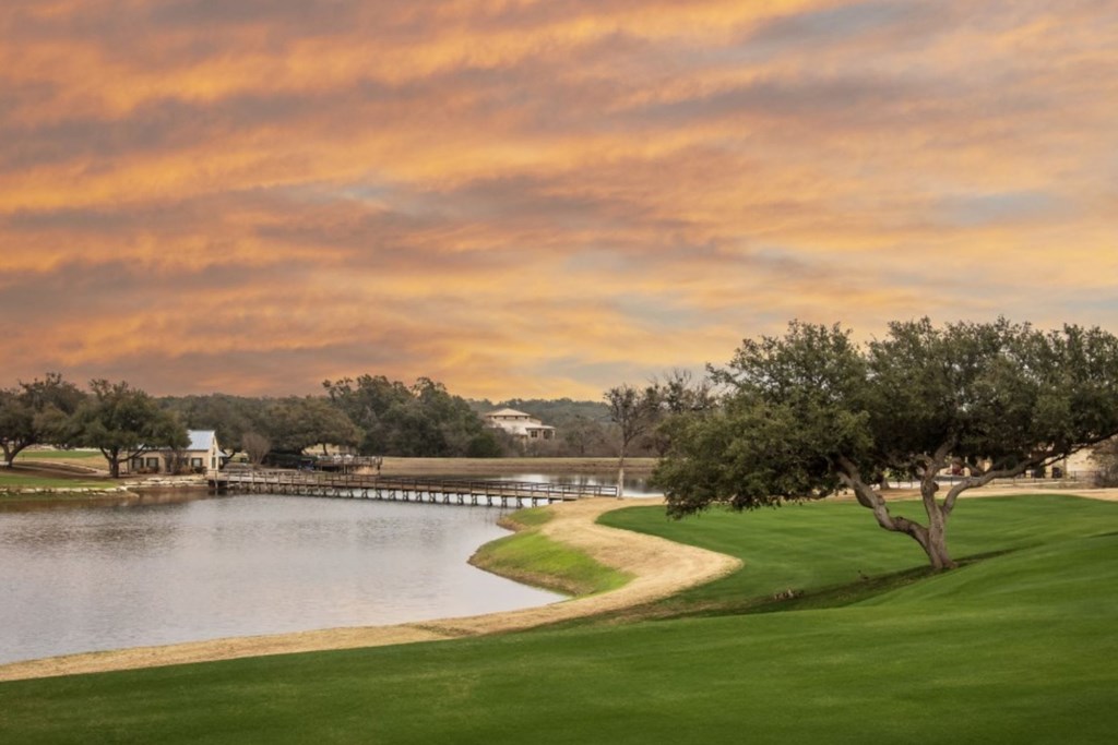 207 North Calvin Barrett, Unit 220 Blanco, TX 78606 - Photo 11 of 18 a view of a lake with houses in the back