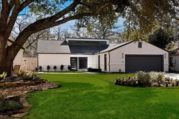 a front view of a house with a garden