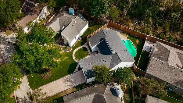 an aerial view of a house with garden space and street view