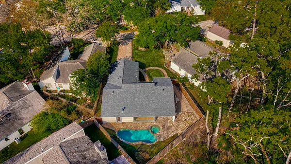 an aerial view of a house with garden space and street view