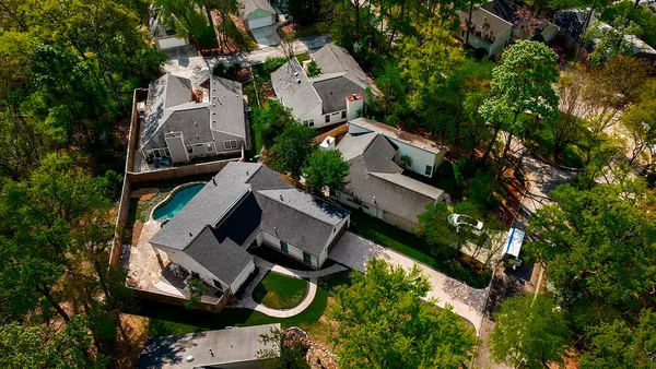 an aerial view of a house with garden space and street view