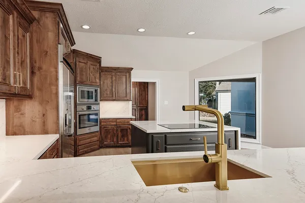 a living room with stainless steel appliances kitchen island granite countertop furniture and a kitchen view