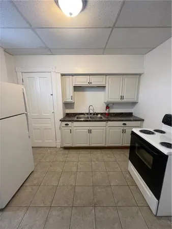 a kitchen with a stove sink and cabinets