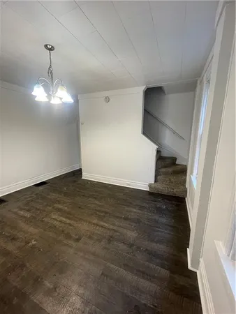 a view of a room with wooden floor and staircase