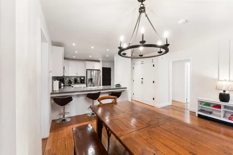a view of kitchen with cabinets and wooden floor