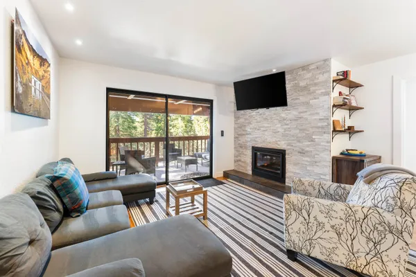 a living room with furniture fireplace and flat screen tv