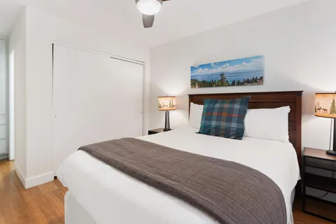 a bedroom with a bed and a mirror