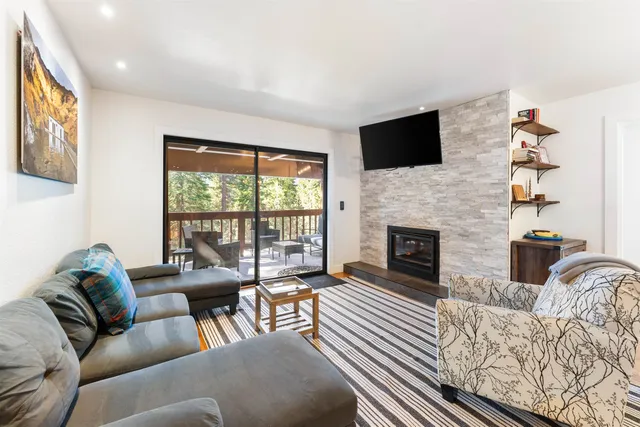 a living room with furniture fireplace and flat screen tv