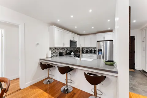 a kitchen with stainless steel appliances granite countertop a sink and cabinets