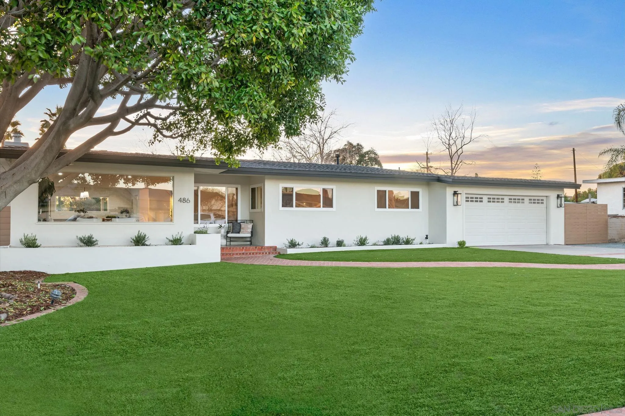 a view of a house with a backyard