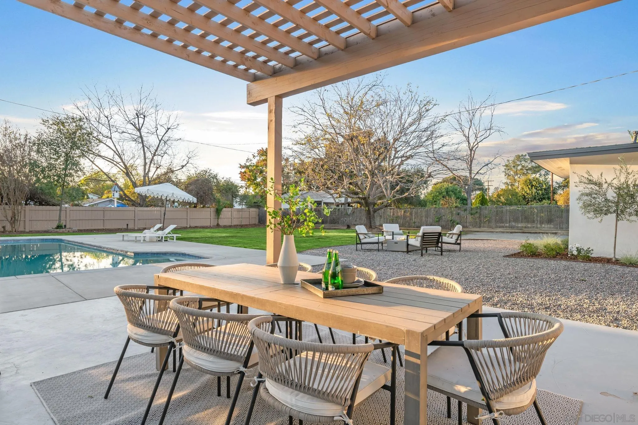 486 Murray Drive El Cajon, CA 92020 - Photo 18 of 22 a patio with table and chairs and couches with wooden fence
