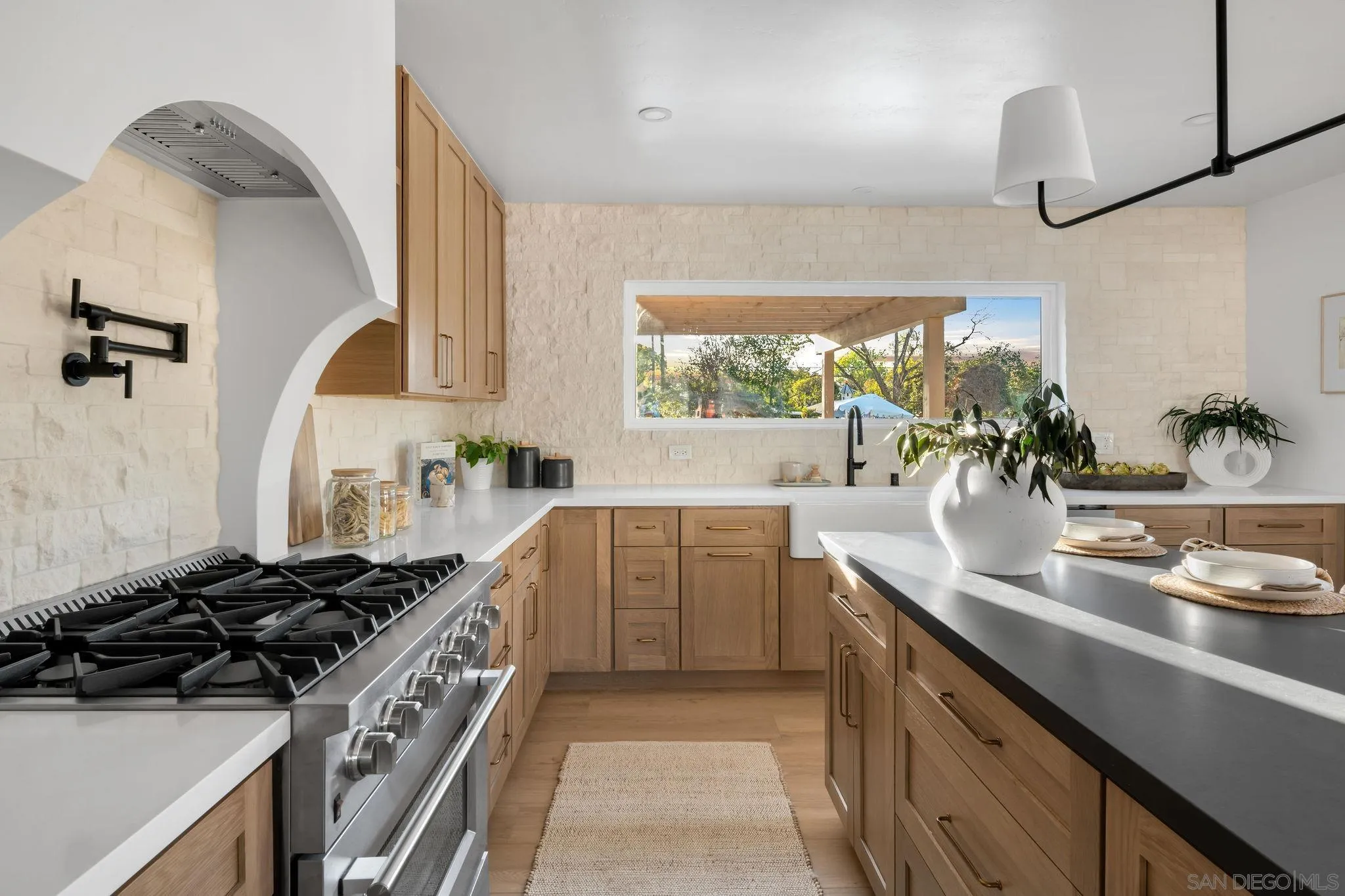 486 Murray Drive El Cajon, CA 92020 - Photo 8 of 22 a kitchen with kitchen island granite countertop a sink stove and cabinets
