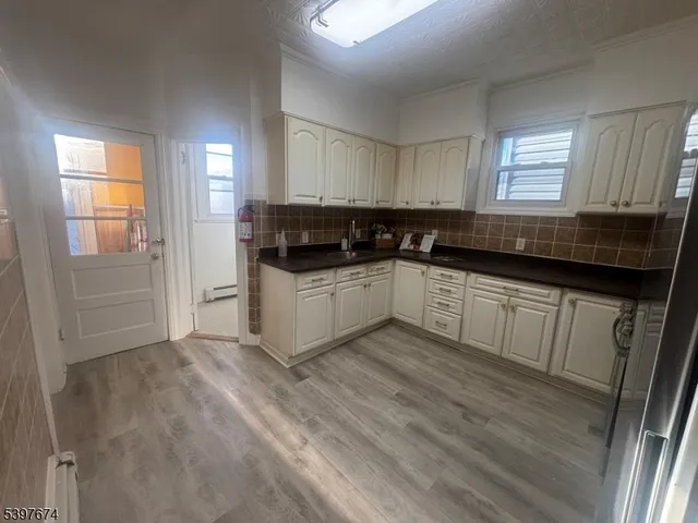 a kitchen with granite countertop a sink and cabinets
