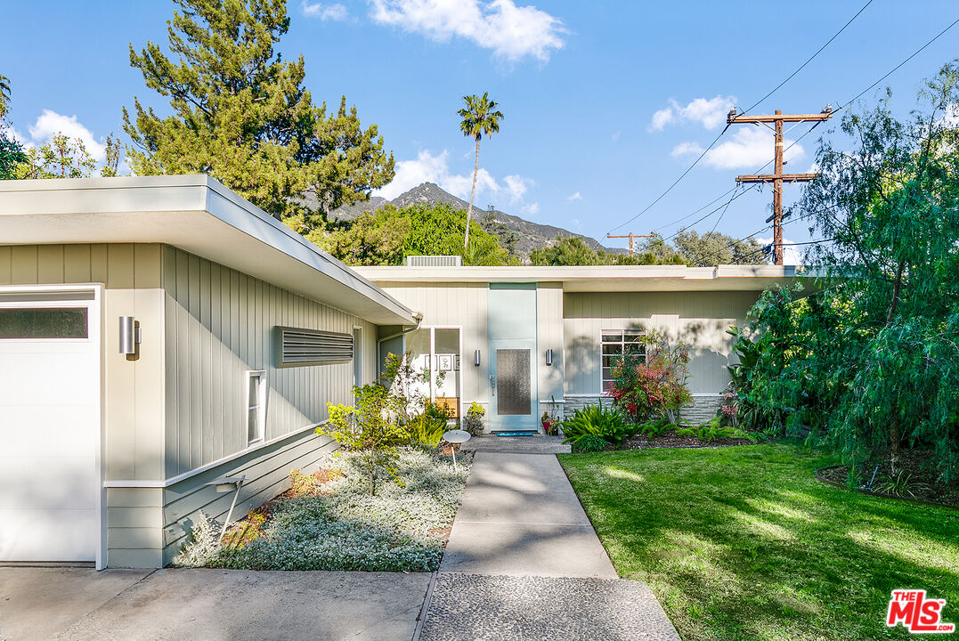 a front view of a house with garden