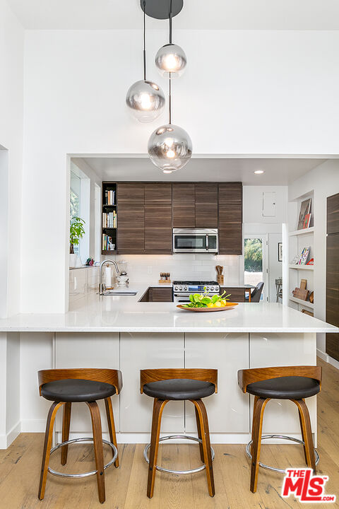 2386 Allen Avenue Altadena, CA 91001 - Photo 14 of 41 a kitchen with a sink and chairs