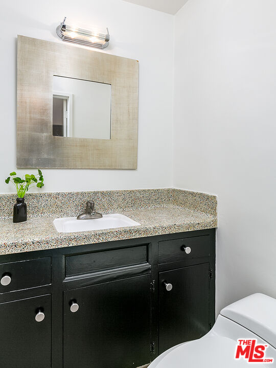 2386 Allen Avenue Altadena, CA 91001 - Photo 19 of 41 a bathroom with a granite countertop sink a toilet and mirror