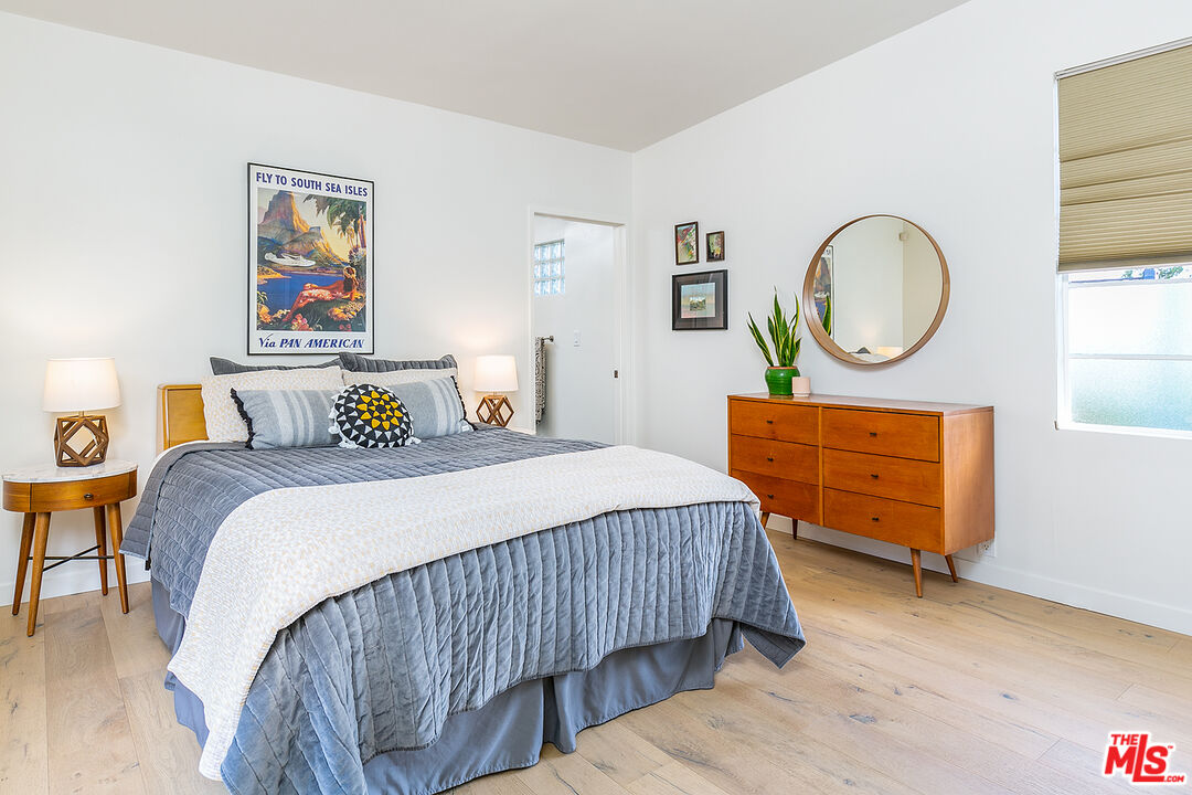 2386 Allen Avenue Altadena, CA 91001 - Photo 20 of 41 a bedroom with a bed a dresser and a potted plant