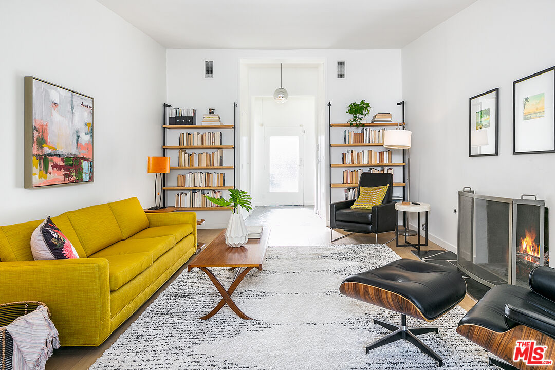 2386 Allen Avenue Altadena, CA 91001 - Photo 8 of 41 a living room with furniture a rug and a bookshelf