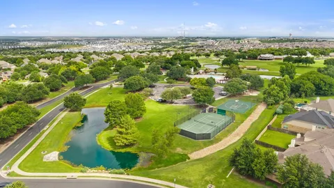an aerial view of a residential houses with outdoor space