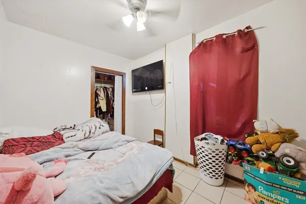 a bedroom with a bed and a tv in it