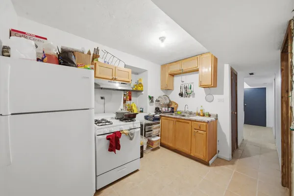 a kitchen with stainless steel appliances a refrigerator sink and cabinets