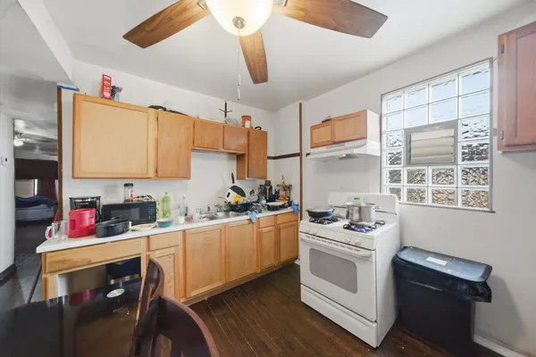 a kitchen with stainless steel appliances a sink stove and cabinets