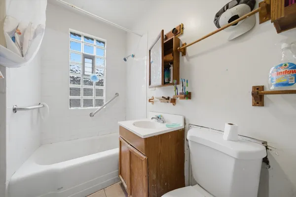 a bathroom with a sink toilet vanity and bathtub
