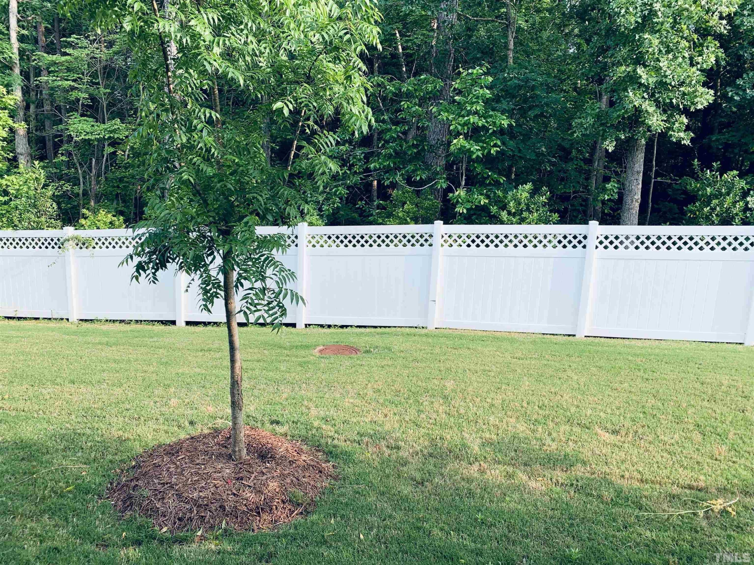 1010 Hero Place Cary, NC 27519 - Photo 12 of 14 a wooden bench sitting in the middle of a field