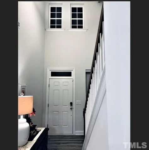 a view of hallway with stairs and furniture