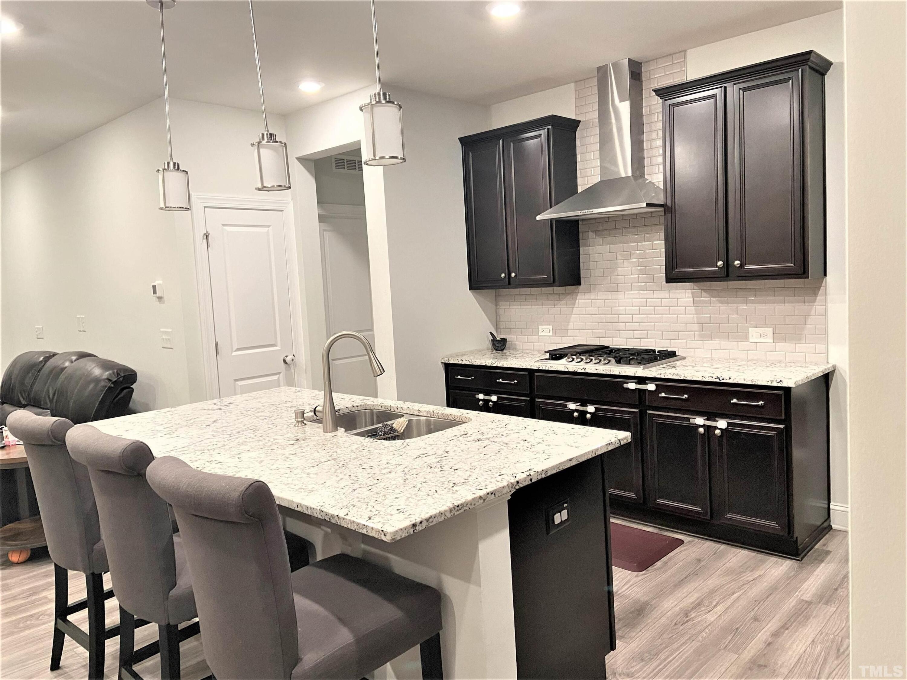 1010 Hero Place Cary, NC 27519 - Photo 7 of 14 a kitchen with stainless steel appliances kitchen island granite countertop a sink a stove and refrigerator