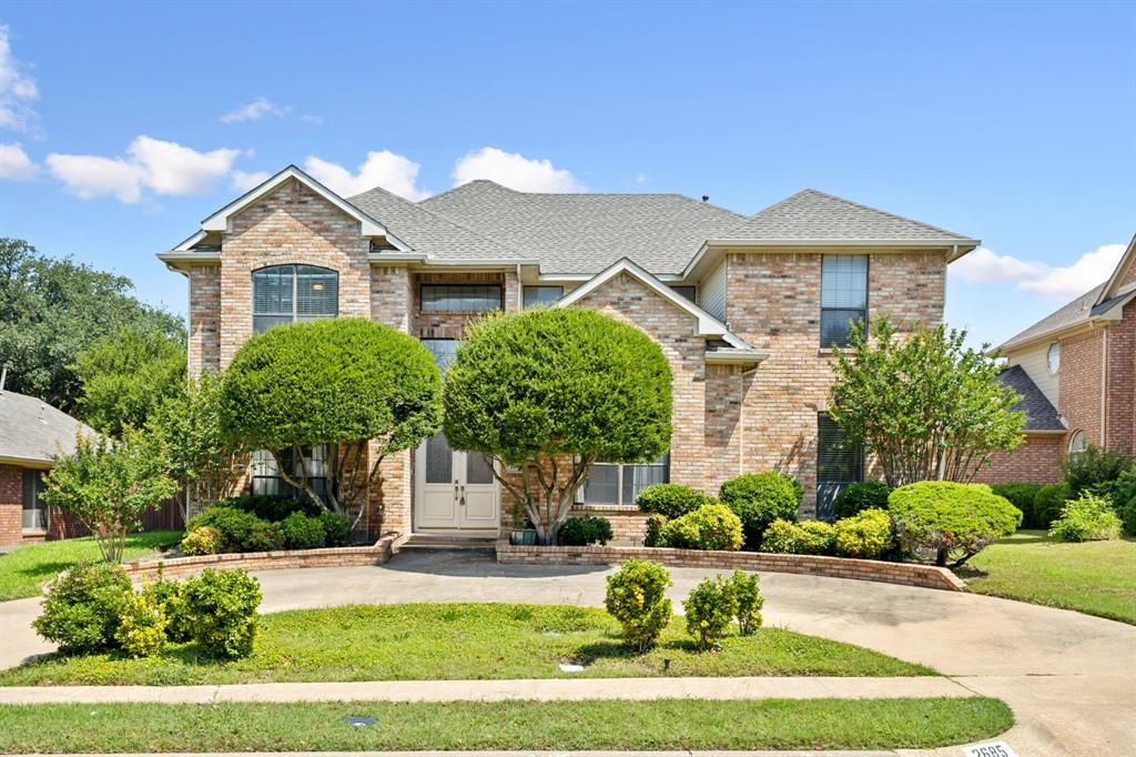 2685 Carnation Drive Richardson, TX 75082 - Photo 1 of 40 a front view of a house with a yard and garage