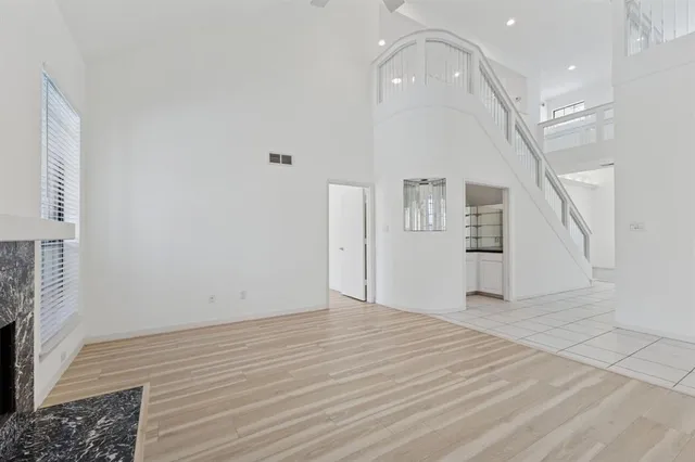 a large white kitchen with cabinets a sink and appliances