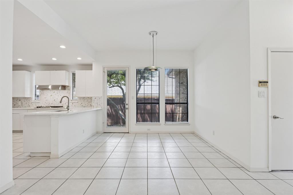 2685 Carnation Drive Richardson, TX 75082 - Photo 14 of 40 a large white kitchen with cabinets a sink and appliances