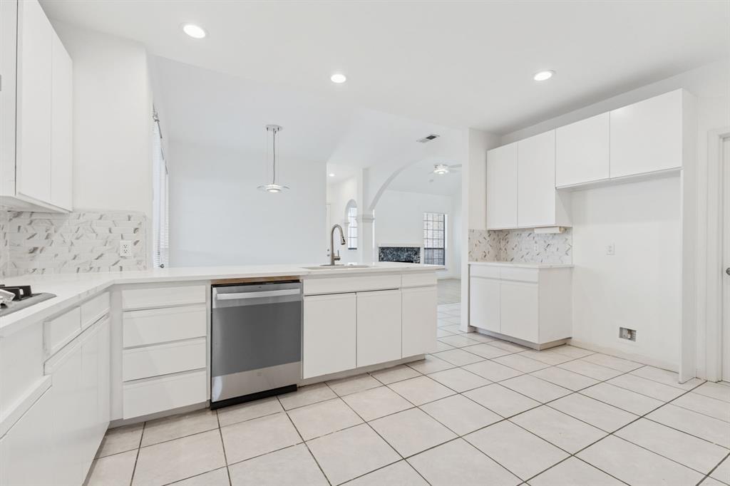 2685 Carnation Drive Richardson, TX 75082 - Photo 18 of 40 a kitchen with white cabinets appliances and a sink