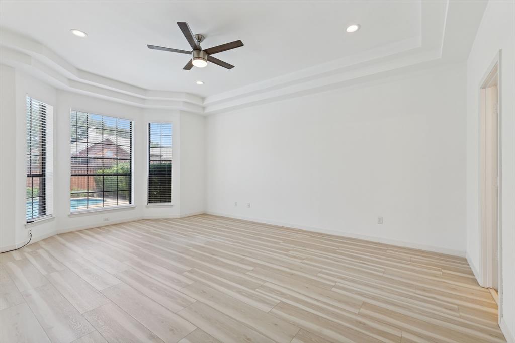 2685 Carnation Drive Richardson, TX 75082 - Photo 19 of 40 an empty room with wooden floor fan and windows