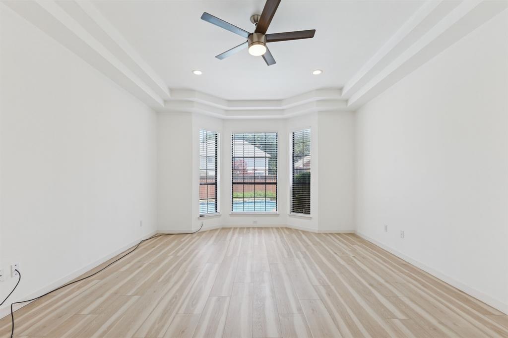 2685 Carnation Drive Richardson, TX 75082 - Photo 20 of 40 an empty room with wooden floor fan and windows