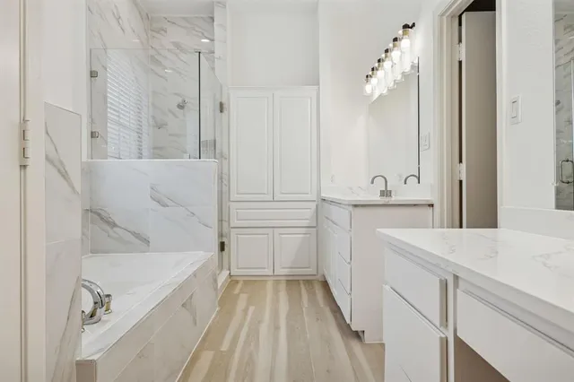 a bathroom with a bathtub and a shower