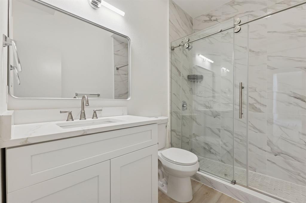 2685 Carnation Drive Richardson, TX 75082 - Photo 27 of 40 a bathroom with a sink a toilet and shower