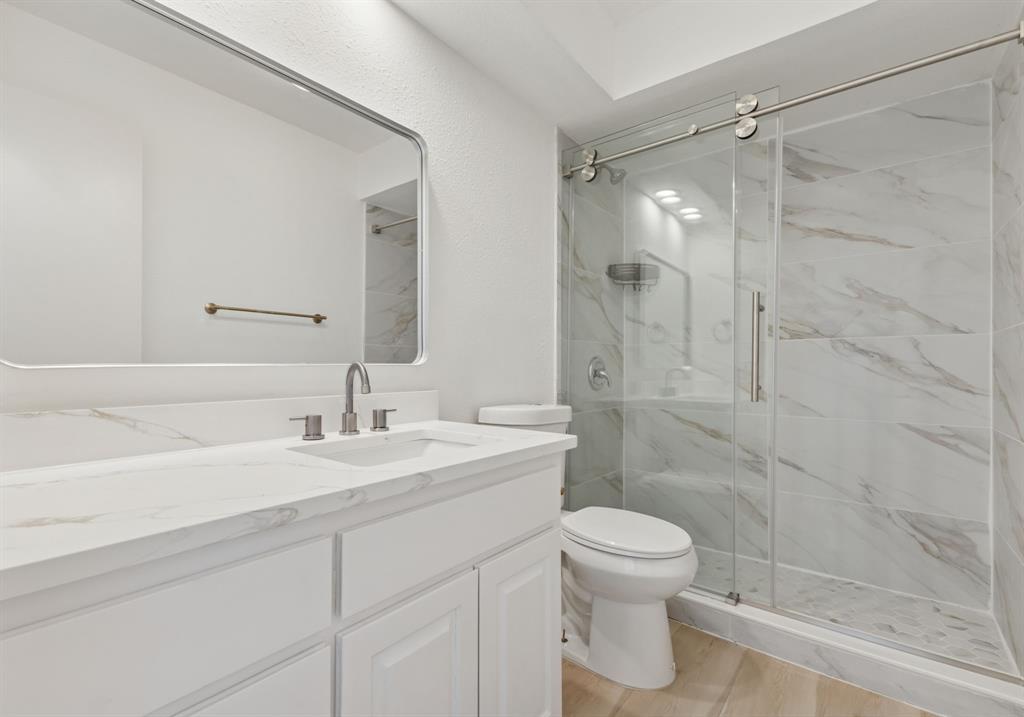 2685 Carnation Drive Richardson, TX 75082 - Photo 31 of 40 a bathroom with a sink toilet a mirror and shower