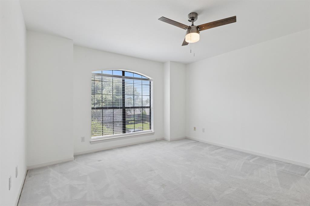 2685 Carnation Drive Richardson, TX 75082 - Photo 33 of 40 an empty room with chandelier fan and windows