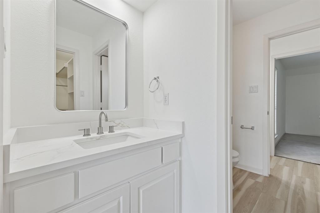 2685 Carnation Drive Richardson, TX 75082 - Photo 34 of 40 a bathroom with a sink and a mirror