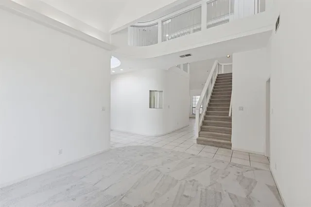 a view of a livingroom with an empty space and a stove top oven