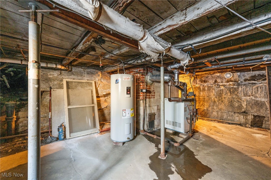 123 South Chillicothe Road Aurora, OH 44202 - Photo 35 of 46 Unfinished basement featuring water heater and a heating unit