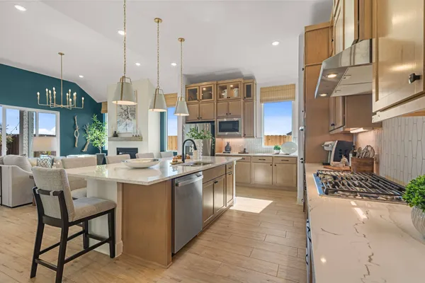 a kitchen with stainless steel appliances granite countertop a sink and a wooden floors